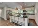 Gourmet kitchen featuring stainless appliances, black countertops, white cabinets, and island seating at 945 Tiber Cir, Alpharetta, GA 30022