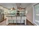 Bright kitchen with stainless steel appliances, dark countertops, and island seating for modern functionality at 945 Tiber Cir, Alpharetta, GA 30022