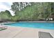 Enjoy a refreshing swim in the community pool surrounded by a privacy fence and mature trees at 945 Tiber Cir, Alpharetta, GA 30022