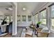 Bright sun room features seating area and adjacent dining room at 945 Tiber Cir, Alpharetta, GA 30022