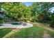 Private backyard with inviting pool, ample seating, and mature trees provides a serene outdoor experience at 1556 Gaylor Se Dr, Smyrna, GA 30082