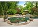 Relax by the refreshing pool with lounge chairs and lush landscaping creating a serene backyard retreat at 1556 Gaylor Se Dr, Smyrna, GA 30082