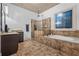Bathroom featuring a large shower, soaking tub, and decorative stained glass window at 1556 Gaylor Se Dr, Smyrna, GA 30082