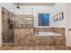 Stunning primary bathroom featuring a glass shower, soaking tub, and beautifully tiled walls at 1556 Gaylor Se Dr, Smyrna, GA 30082