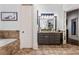 Bathroom featuring granite counters, ceramic tile, and a step-up tub at 1556 Gaylor Se Dr, Smyrna, GA 30082