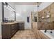 Luxurious bathroom with double vanity, granite countertops, glass shower, and soaking tub at 1556 Gaylor Se Dr, Smyrna, GA 30082