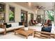 Enjoy the covered patio with comfortable seating, ceiling fans, and elegant lighting for outdoor living at 1556 Gaylor Se Dr, Smyrna, GA 30082