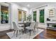 Bright dining room with large windows and doors for natural light, and a modern table setting at 1556 Gaylor Se Dr, Smyrna, GA 30082