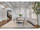 Elegant dining room with coffered ceilings, modern chandelier, and large windows providing natural light at 1556 Gaylor Se Dr, Smyrna, GA 30082