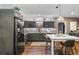 Stylish kitchen featuring stainless steel appliances, dark cabinets, an eat-in area and designer backsplash at 1556 Gaylor Se Dr, Smyrna, GA 30082