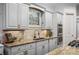 Close-up of kitchen featuring granite countertops, a stylish backsplash, and stainless steel double ovens at 1556 Gaylor Se Dr, Smyrna, GA 30082