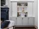 Living room with a black fireplace and custom gray built-ins featuring glass shelving at 1556 Gaylor Se Dr, Smyrna, GA 30082