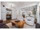 Spacious living area featuring hardwood floors, neutral decor, and modern light fixtures, flowing into dining area at 1556 Gaylor Se Dr, Smyrna, GA 30082