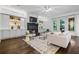 Bright living room with custom built-ins, a sleek black fireplace, and lots of natural light at 1556 Gaylor Se Dr, Smyrna, GA 30082