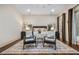Bright main bedroom with hardwood floors, two chairs, and a large area rug at 1556 Gaylor Se Dr, Smyrna, GA 30082