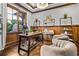 Bright home office with decorative wood trim, featuring a large window and neutral walls for focus and comfort at 1556 Gaylor Se Dr, Smyrna, GA 30082