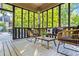 Inviting screened porch perfect for outdoor entertaining with comfortable seating and wooded views at 1556 Gaylor Se Dr, Smyrna, GA 30082