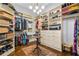 Spacious walk-in closet with custom shelving and drawers, and a decorative area rug at 1556 Gaylor Se Dr, Smyrna, GA 30082