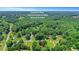 An aerial view of a wooded residential area, with text indicating distances to nearby cities at 1605 Saddlecreek Rd, Auburn, GA 30011