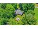 Lush trees surround this home with a back patio complete with outdoor table and chairs at 1605 Saddlecreek Rd, Auburn, GA 30011