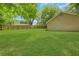 Huge backyard with green grass and a wood fence, mature trees at 1605 Saddlecreek Rd, Auburn, GA 30011