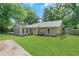 Spacious backyard with a sunroom and a well-maintained lawn perfect for outdoor activities at 1605 Saddlecreek Rd, Auburn, GA 30011