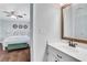 Bathroom featuring a decorative mirror, hardwood floors and modern finishes at 1605 Saddlecreek Rd, Auburn, GA 30011