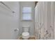 Bathroom with toilet, white walls, and a shower curtain at 1605 Saddlecreek Rd, Auburn, GA 30011
