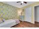 Bedroom features floral wallpaper, ceiling fan, and wood floor at 1605 Saddlecreek Rd, Auburn, GA 30011