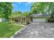 A well maintained home with a driveway leading to an attached two-car garage at 1605 Saddlecreek Rd, Auburn, GA 30011
