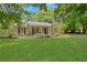 Charming ranch-style home featuring a well-manicured lawn and inviting front porch at 1605 Saddlecreek Rd, Auburn, GA 30011