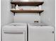 This laundry room features side by side front-load washers and dryers at 1605 Saddlecreek Rd, Auburn, GA 30011