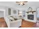 Open-concept living room with hardwood floors and a cozy fireplace at 1605 Saddlecreek Rd, Auburn, GA 30011