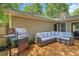 Wooden deck and patio area featuring a built-in seating area and a grill at 1605 Saddlecreek Rd, Auburn, GA 30011