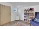 Inside view of the storage room, vinyl flooring, shelving with disc golf discs, and a portable air conditioner at 1605 Saddlecreek Rd, Auburn, GA 30011