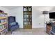 Interior view of the storage room, showing a bookshelf, chair, and part of shelves with disc golf discs at 1605 Saddlecreek Rd, Auburn, GA 30011