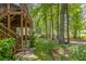 Well-maintained backyard with mature trees and paver walkway leading to an outdoor living area at 1668 Macy Ln, Lawrenceville, GA 30043
