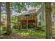 Spacious backyard featuring a multi-level deck, covered patio area, and mature trees at 1668 Macy Ln, Lawrenceville, GA 30043