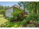 Lovely backyard view of a two-story home with a spacious deck and beautiful landscaping at 1668 Macy Ln, Lawrenceville, GA 30043