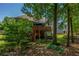 Backyard showcasing a large wooden deck, patio area, and lush greenery in a peaceful setting at 1668 Macy Ln, Lawrenceville, GA 30043