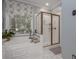 Bright bathroom features a soaking tub under a window and a glass-door shower at 1668 Macy Ln, Lawrenceville, GA 30043
