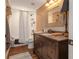 Charming bathroom boasts a granite countertop, decorative mirror, and a shower with tub at 1668 Macy Ln, Lawrenceville, GA 30043