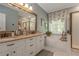 A luxurious bathroom features dual sinks, a soaking tub, and separate shower with updated fixtures at 1668 Macy Ln, Lawrenceville, GA 30043