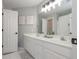 Bright bathroom with double vanity and framed mirror at 1668 Macy Ln, Lawrenceville, GA 30043