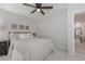 Cozy bedroom featuring neutral tones, ceiling fan, carpet, and natural light at 1668 Macy Ln, Lawrenceville, GA 30043
