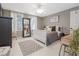 Stylish bedroom with windows, carpet, decor, and an accent mirror at 1668 Macy Ln, Lawrenceville, GA 30043