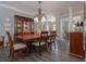 Formal dining room showcases hardwood floors, a china cabinet, and a chandelier at 1668 Macy Ln, Lawrenceville, GA 30043