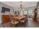 Charming dining area with wood table, decorative chandelier, and window views for delightful meals at 1668 Macy Ln, Lawrenceville, GA 30043