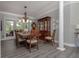 Traditional dining room features a wooden table, chandelier, and china cabinet for elegant meals and gatherings at 1668 Macy Ln, Lawrenceville, GA 30043