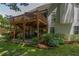 Exterior view featuring a two-story deck, a brick patio, and lush, mature landscaping at 1668 Macy Ln, Lawrenceville, GA 30043